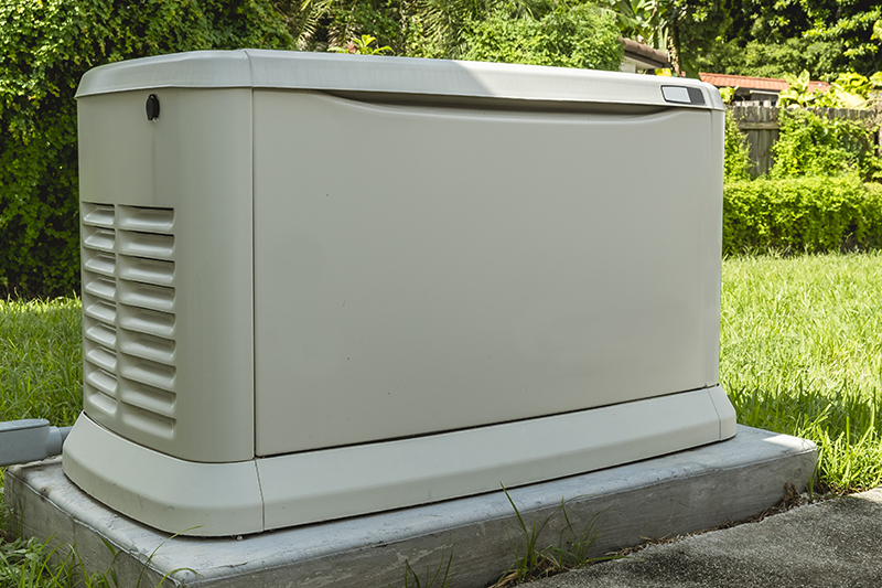 Why Invest in a Whole-Home Generator? A Home Standby Generator installed at the backyard of a house. An air-cooled natural gas or liquid propane generator for residential use.